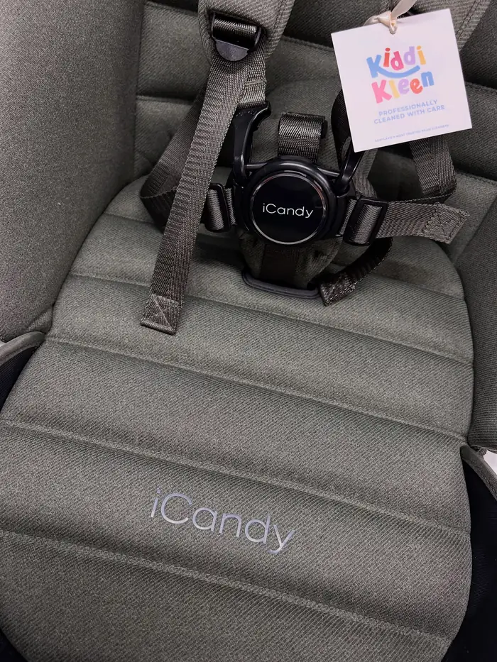 A green iCandy seat unit after cleaning, with a Kiddi Kleen tag